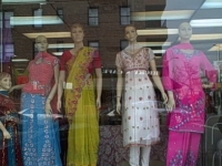 South Asian women's dress depicted in this storefront. This is a very common sari shop window in Jackson Heights, depicting women as beautiful, colorful, and ethnically traditional.