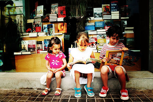 South Asian children reading outside of a bookstore in Jackson Heights.